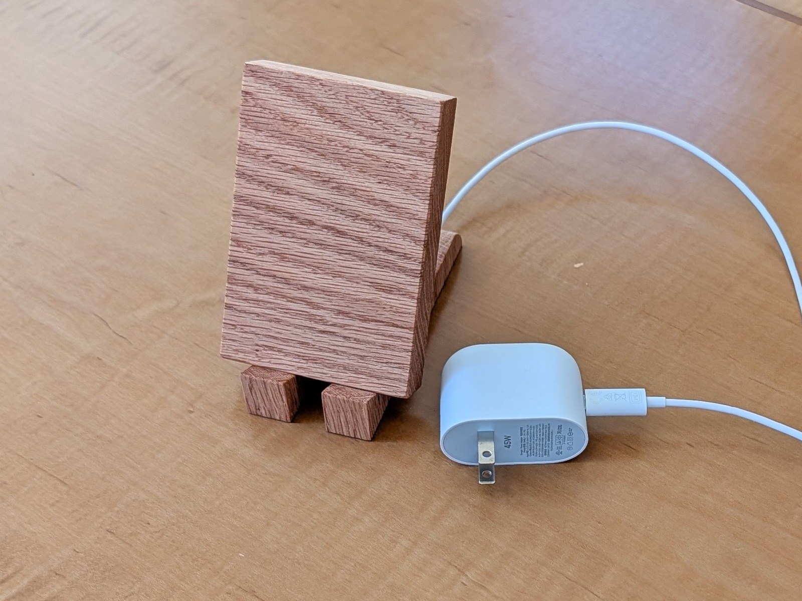Wireless charging stand — Oak, charging puck pocketed into the back