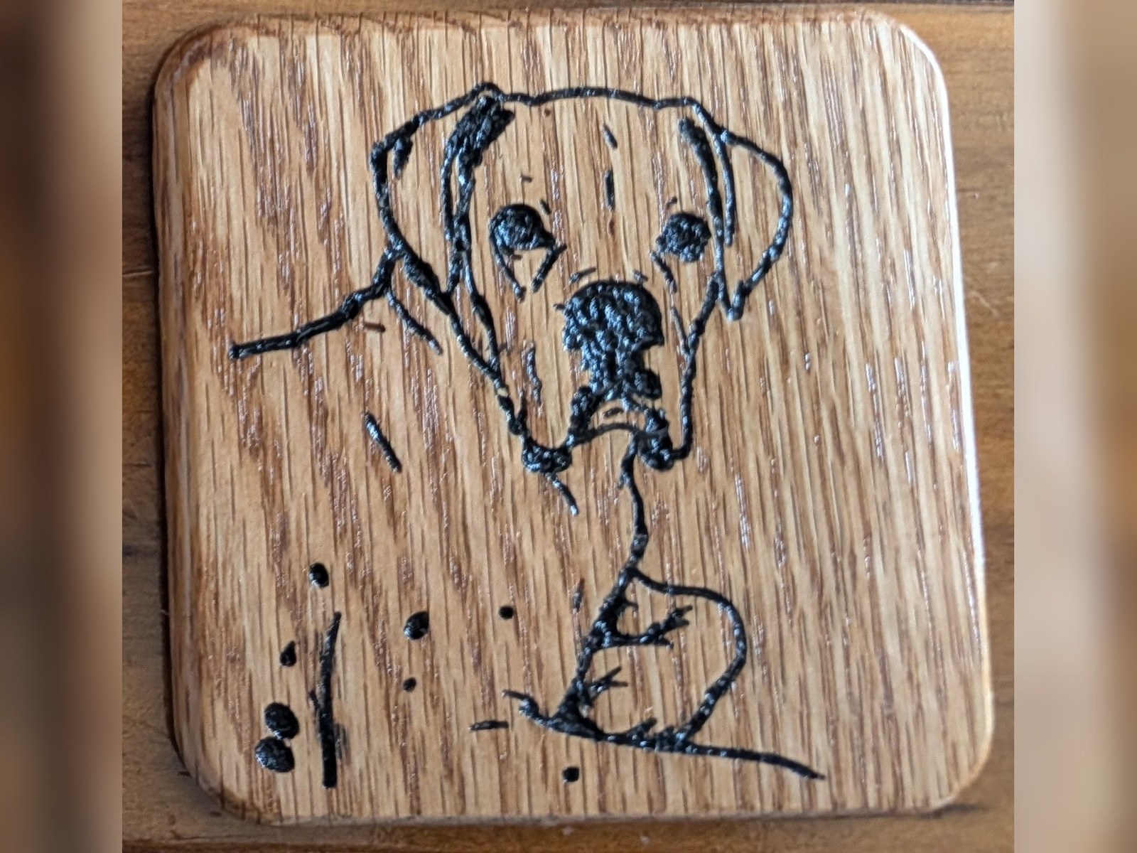 Dog portrait — Oak, carved inlay filled black