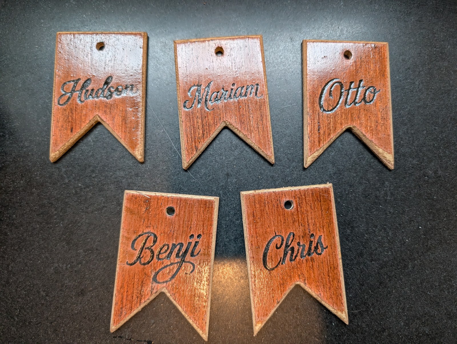 Swallowtail name tags — Stained, carved and filled