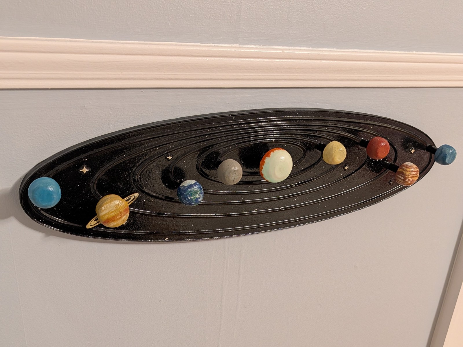 Solar system coat rack — Lacquered black, turned planets for hooks